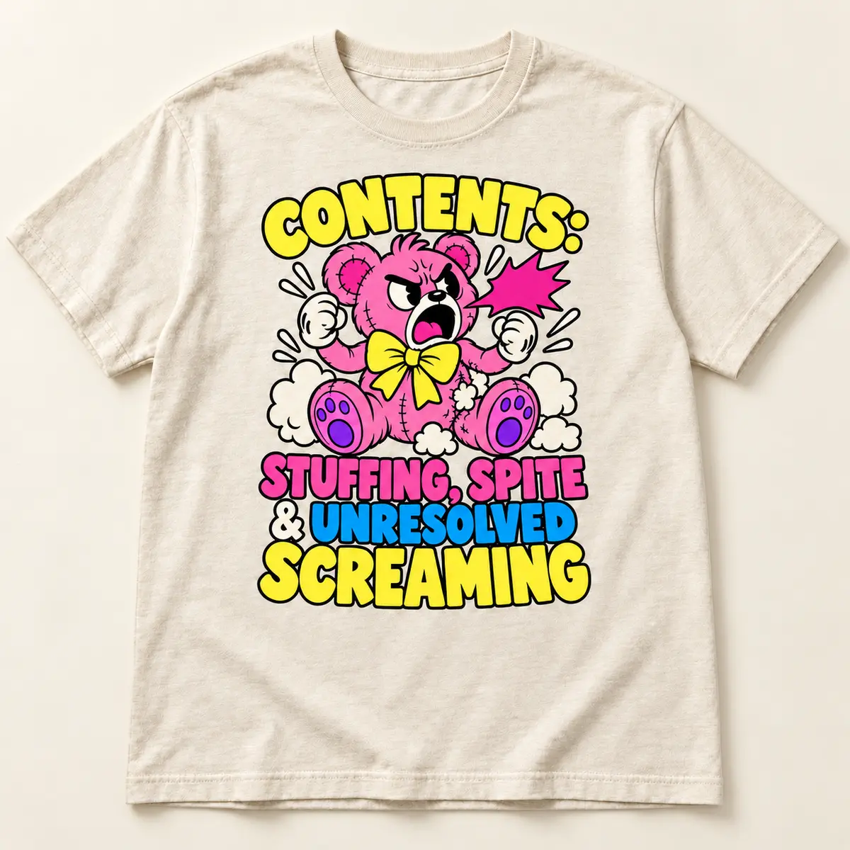 Natural cream t-shirt featuring the Little Liabilities Stuffing and Spite cartoon design: CONTENTS:; STUFFING, SPITE; & UNRESOLVED; SCREAMING; pink teddy bear shouting with loose stuffing